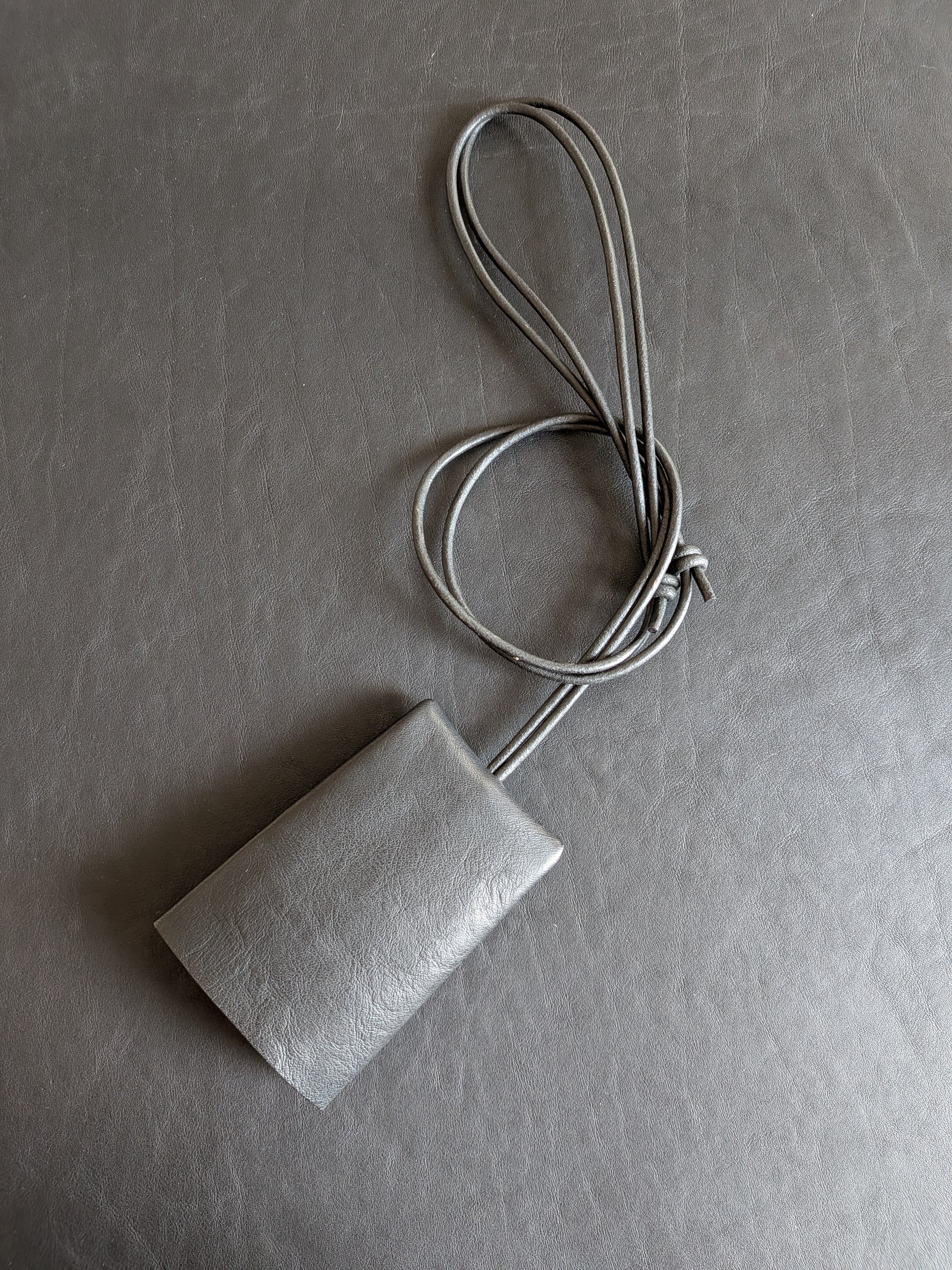 Rectangular key lanyard  with a adjustable cord on a black background