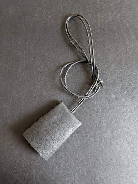 Rectangular key lanyard  with a adjustable cord on a black background